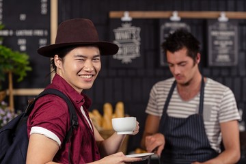 Happy customer drinking coffee