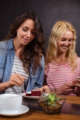 Smiling brunette enjoying a pastry