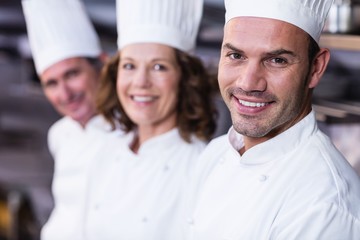 Group of happy chefs smiling at the camera 