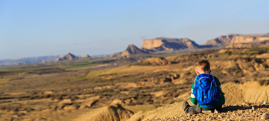 little boy travel in mountains