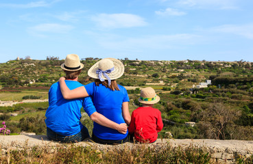 family with small kid looking at scenic country views