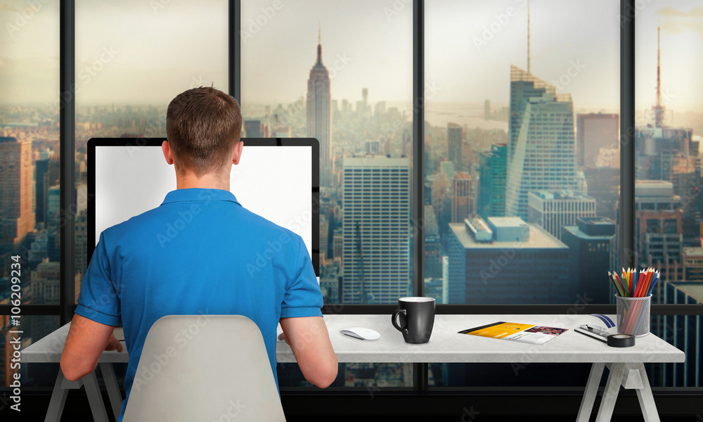 Poster man working on computer with isolated screen in office interior overlooking the city and skyscrapers