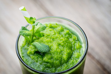 Rucola smoothie, on the grey  background.