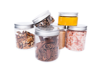 Plastic containers with cinnamon, walnuts, salt, sugar and other