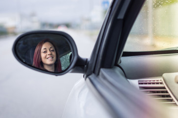 Fototapeta na wymiar Attractive young caucasian girl driving a car 