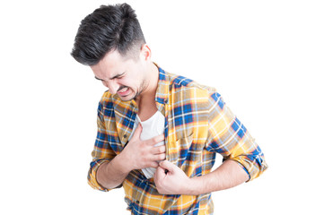 Young man holding hand to his chest during heart attack
