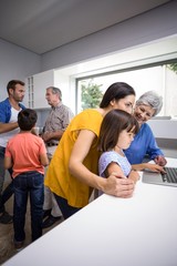 Fototapeta premium Happy family interacting using laptop