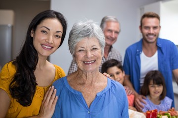 Elderly woman and young woman standing in kitchen
