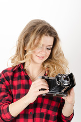 young woman holding old camera