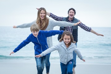 Fototapeta na wymiar Children enjoying with parents at sea shore