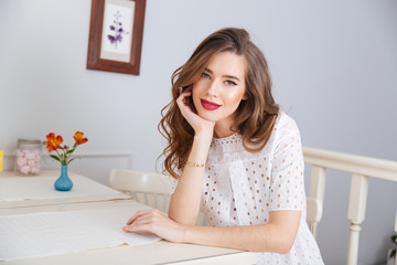 Happy beautiful young woman sitting in cafe