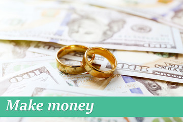 Wedding rings on money background, close up