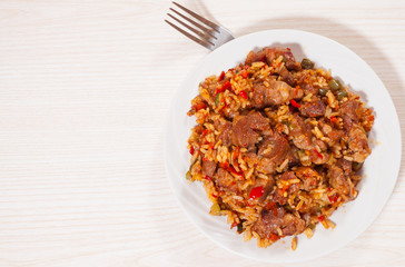 Rice with meat and vegetables on plate