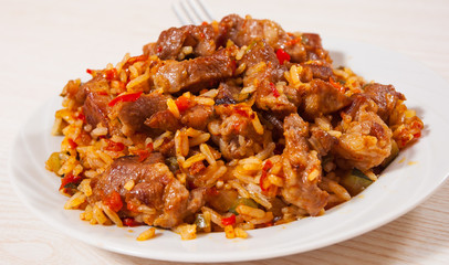 Rice with meat and vegetables on plate