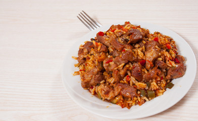 Rice with meat and vegetables on plate
