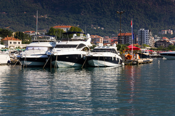 Fototapeta na wymiar View on the pier with boats in Budva.