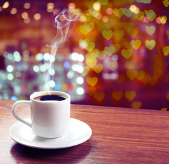 Cup of coffee on table on blured cafe background
