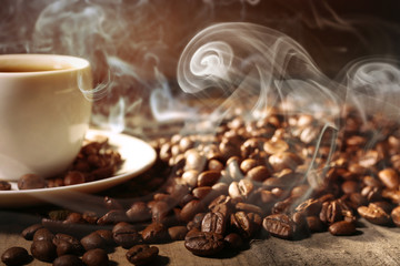 Cup of coffee and grains, closeup