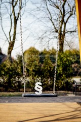 White paragraph symbol on children chain swing.