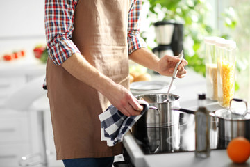 Man cooking dinner in bright kitchen