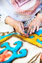 Fototapeta na wymiar Kazakh woman making pattern