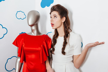 Woman talking with manikin