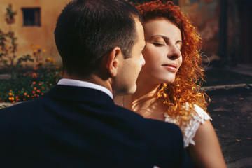 Fototapeta premium stylish luxury red haired bride and elegant groom, hugging with