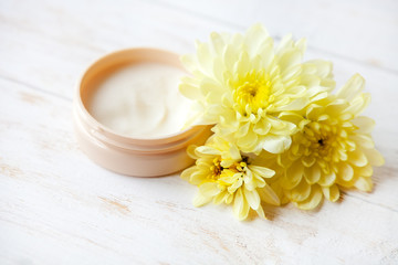 Fototapeta na wymiar cream with blossom on wooden table