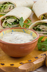 Cold wraps with ham, iceberg lettuce and yogurt sauce