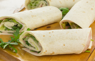 Cold wraps filled with ham and iceberg lettuce