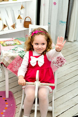 Little lovely smiling girl on the wooden toy horse in the interi © ribalka yuli