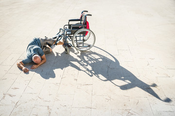 Disabled man with handicap having an accident crash with wheelchair - Disability concept with...