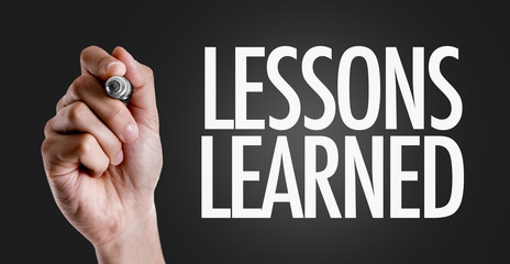 Hand writing the text: Lessons Learned