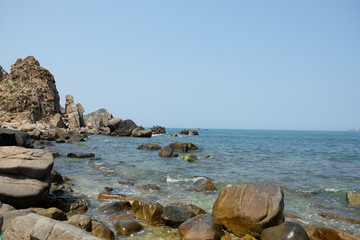 Fototapeta na wymiar Rocks in the blue sea of Eo Gio cape, Binh Dinh province, Vietnam.