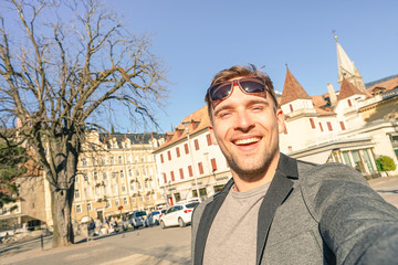 Young handsome man taking selfie at Meran old town in South Tyrol in Italy - Adventure and travel...