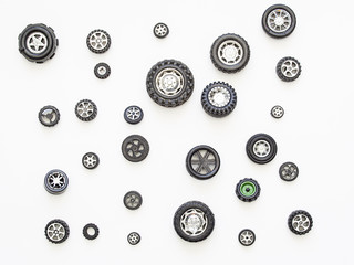 Toy wheels on a white background pattern.