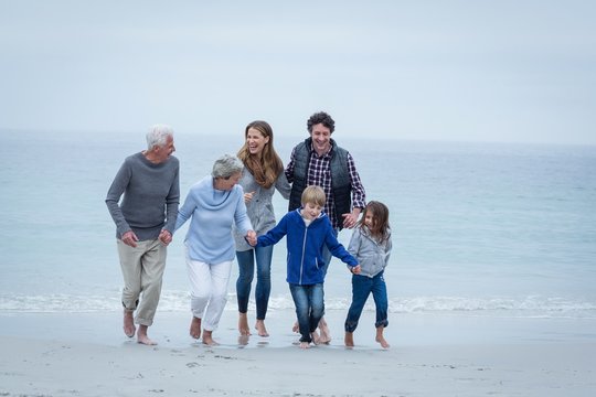 Happy multi-generation family enjoying at sea shore