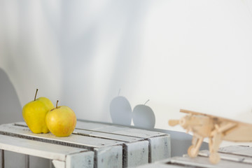 Shadows of two apples on wall