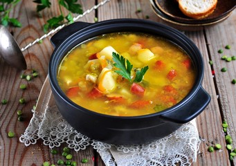Soup of dry peas, vegetables with smoked sausage