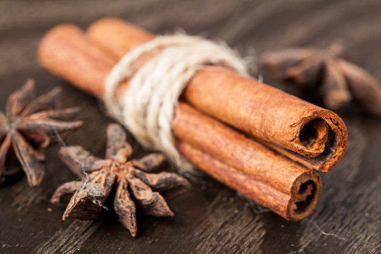 Cinnamon sticks and star anise on a wooden board. Selective focus.