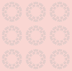 A pink circular floral pattern.