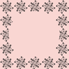 A floral pattern forming a frame on pink background with copy space.