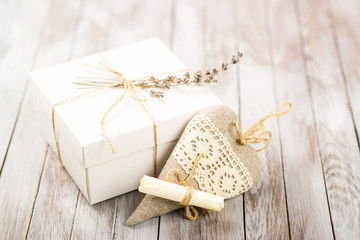 White gift box with rustic twine and a sprig of lavender with ha