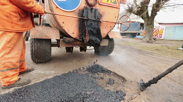 Road workers laid asphalt, repairing the road