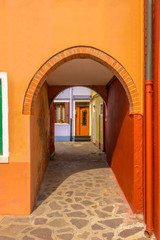 Fototapeta premium Entrance of a colorful apartment building in Burano, Venice, Italy.