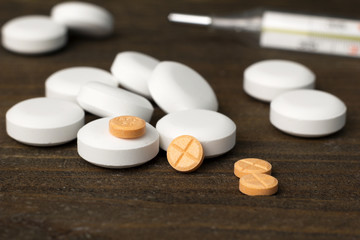 bunch of white and orange pills  closeup