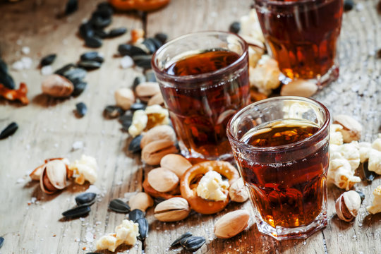 Cola glasses, sweet and savory snacks, old wooden table, unhealt