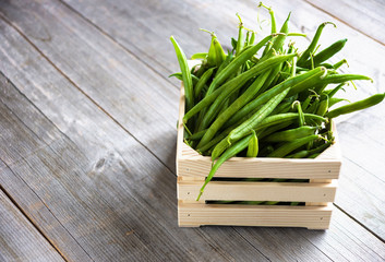 Green beans on wooden background