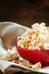 Homemade sweet popcorn in a red bowl, selective focus