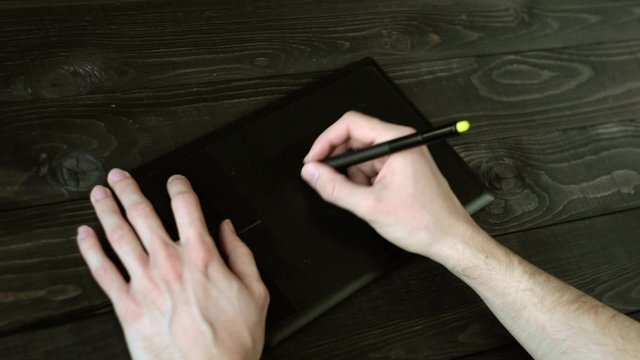 men painting using graphic tablet
